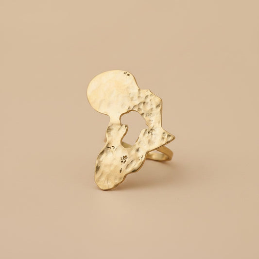 Tinkers oversized brass ring featuring a large, textured, organic-shaped disc with a brushed satin finish.