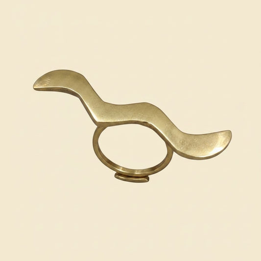 Tinkers handmade raw brass wrap ring featuring a sculptural wavy S-curve design with a matte brushed finish.