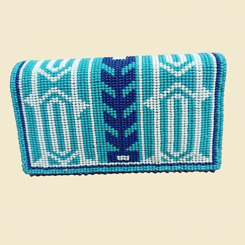 Turquoise and Navy Geometric Beaded Clutch on cream background