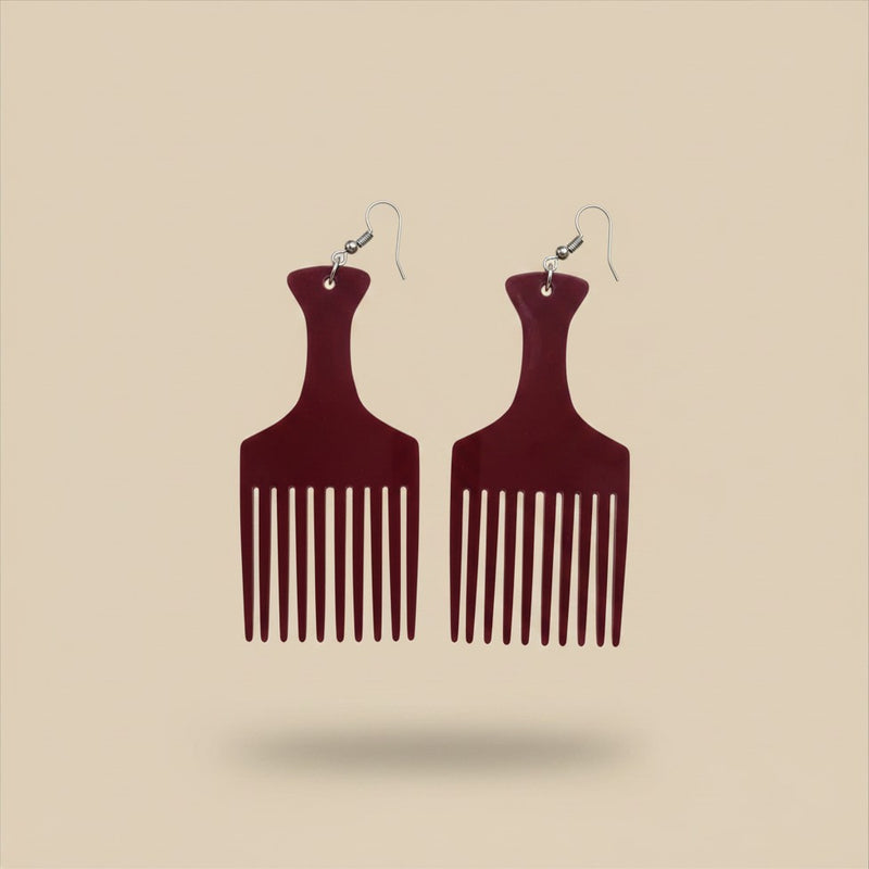 Close-up flat lay of the Burgundy Heritage Comb Earrings in wine red with silver hook findings, on a plain beige background.