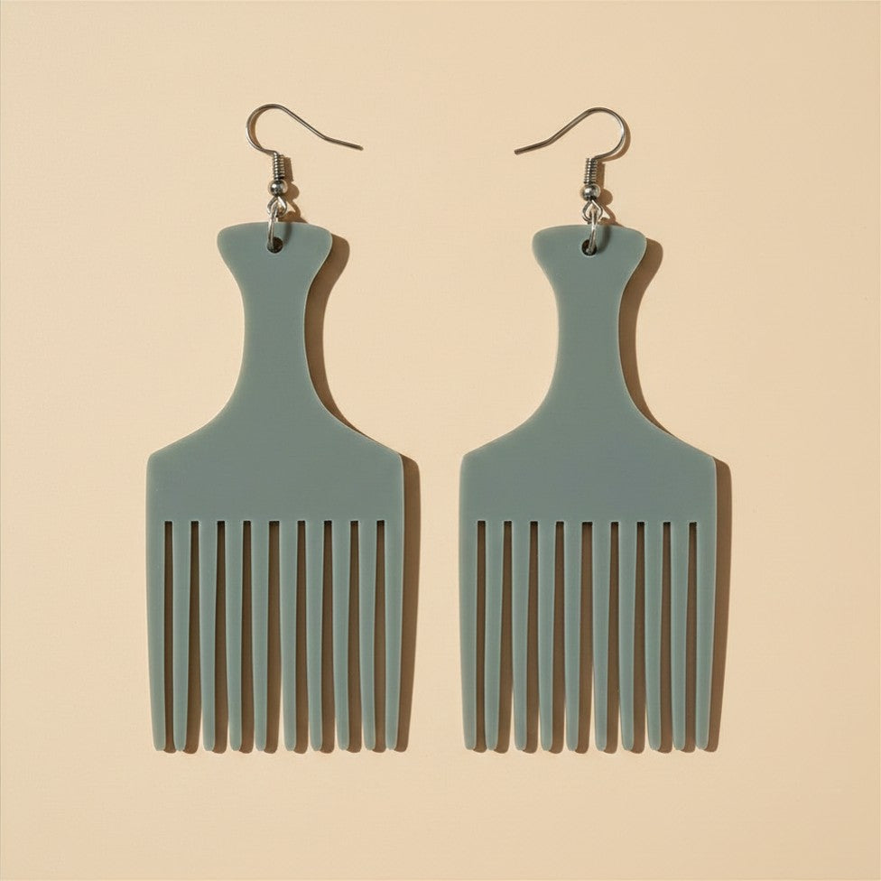 Close-up flat lay of the Mist Grey Heritage Comb Earrings in sage grey-green with silver hook findings, on a plain light beige background.