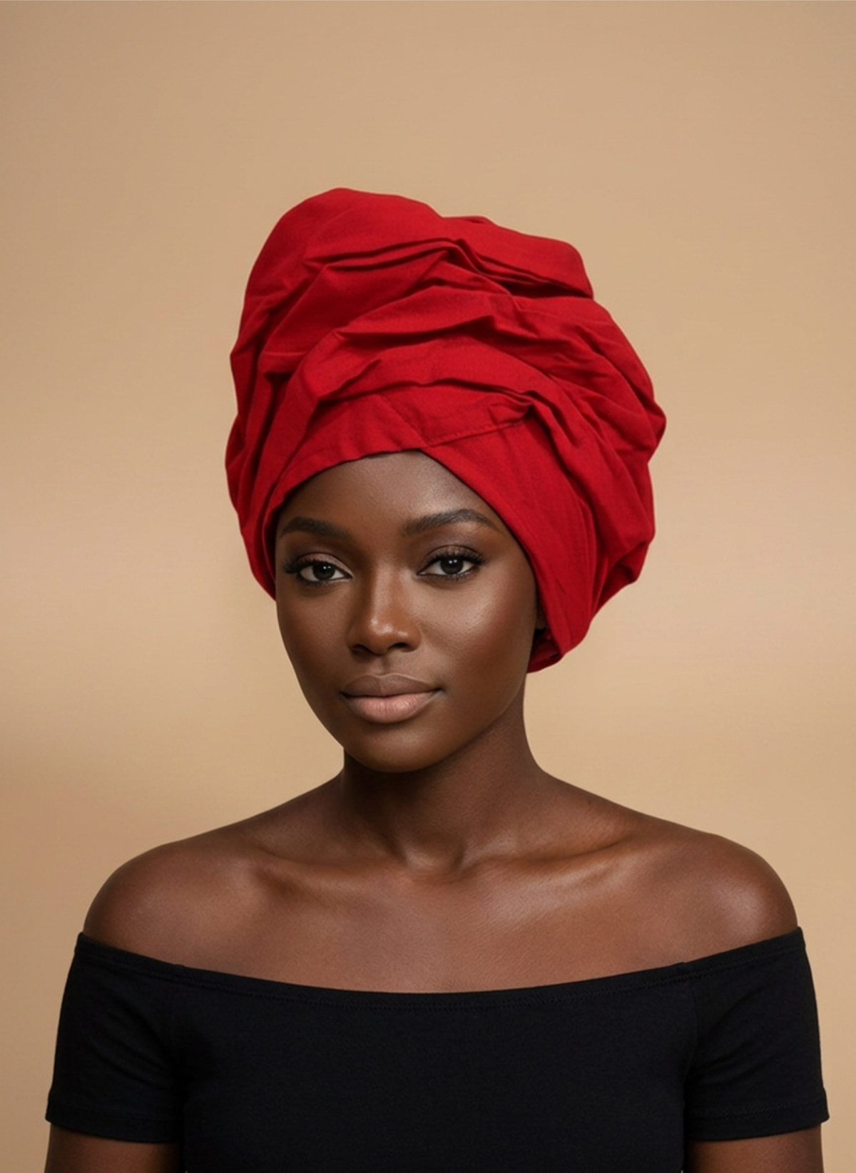 Model wearing the Ruby Elegance ready-to-wear African headwrap in solid red, tied in a gathered knot, against a plain beige background.