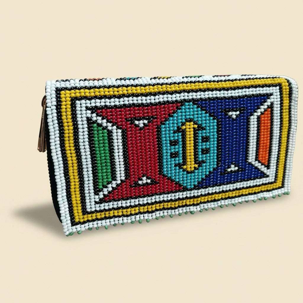 Tinkers handcrafted beaded zip wallet featuring a vibrant geometric Ndebele pattern in yellow, red, blue, and turquoise.