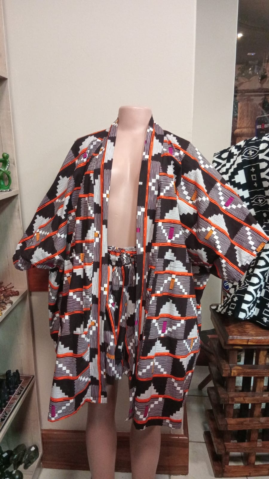 Tinkers kimono style jacket and shorts set featuring a vibrant geometric tribal print in black, white, orange, and magenta