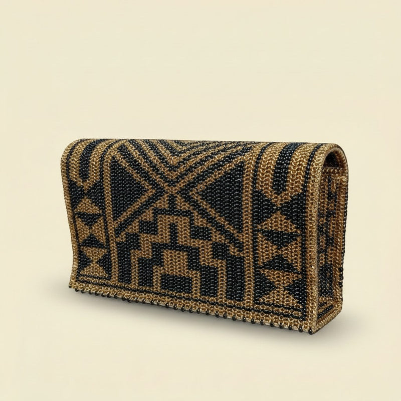Tinkers handcrafted leopard print clutch with metallic gold and black seed beads in a structured arched silhouette.