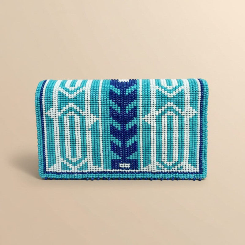 Tinkers turquoise, navy, and white geometric beaded clutch with a central zigzag motif and arched lid design.