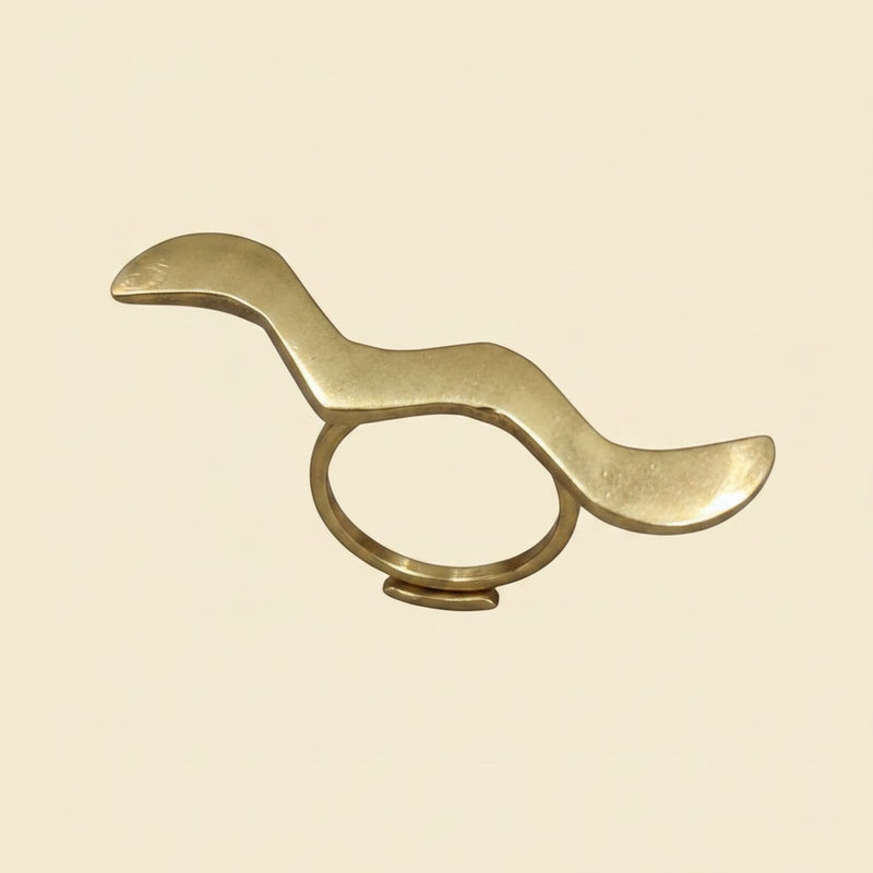 Tinkers handmade raw brass wrap ring featuring a sculptural wavy S-curve design with a matte brushed finish.